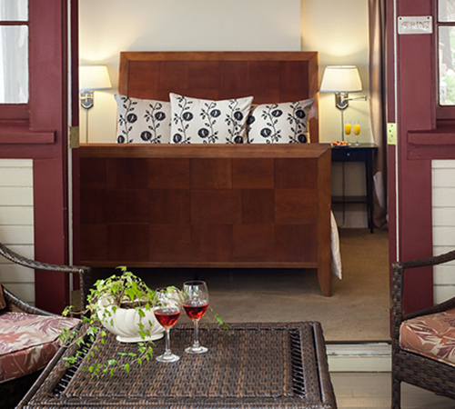Outside view of the patio with two red wine glasses on patio table from the Spring room at the Craftsman Inn in Calistoga, CA; Wine Country, Napa Valley