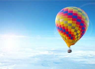 Sky view of colorful hot air balloons over clouds in the Napa Valley Wine Country