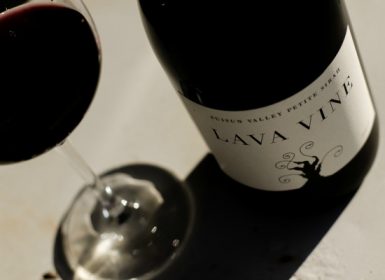 Black and white picture of red wine glass and bottle from Lava Vine wine tasting room in Calistoga, CA, the Napa Valley Wine Country