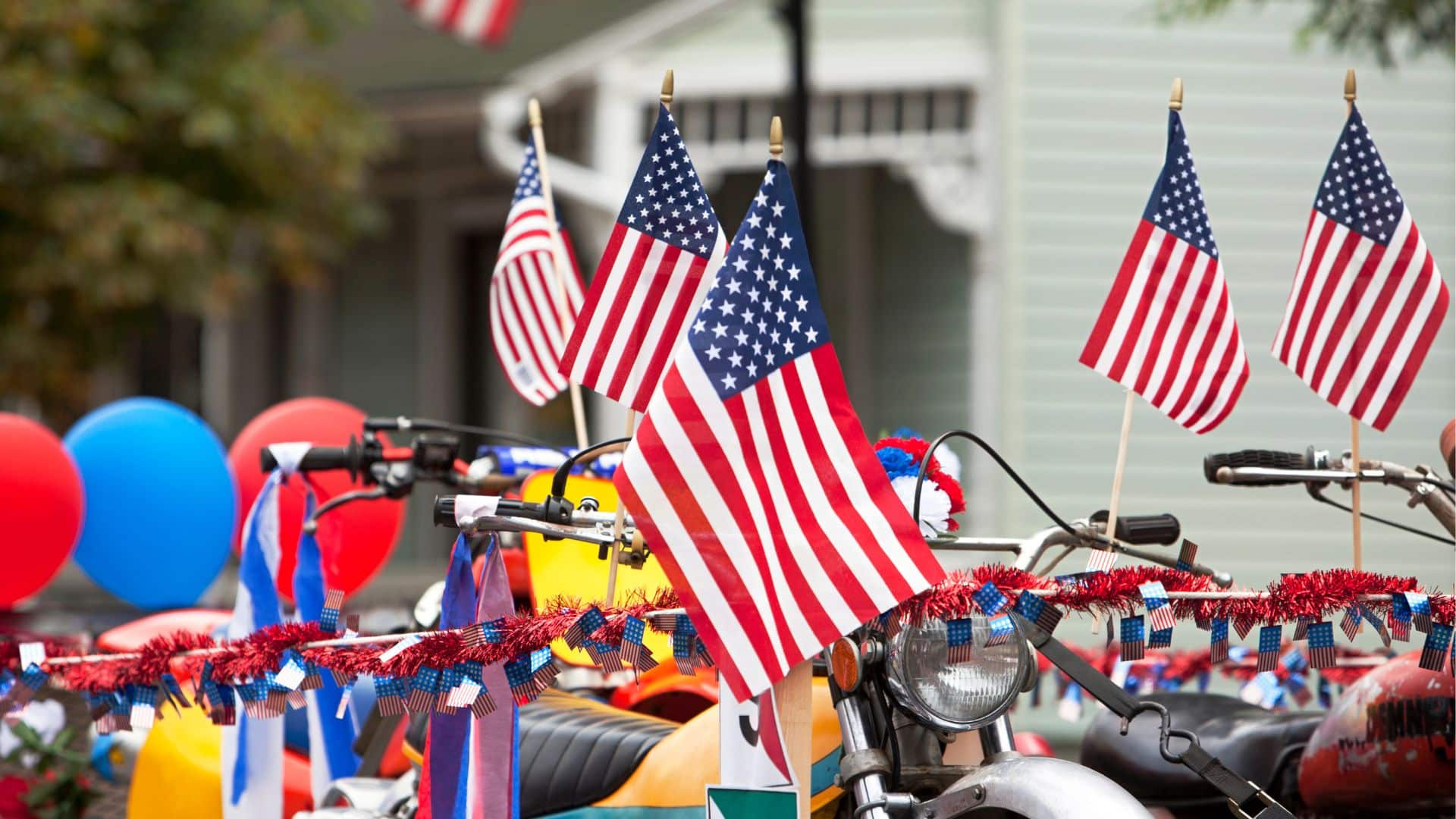a float decorated for a 4th of july parade. many american flags.