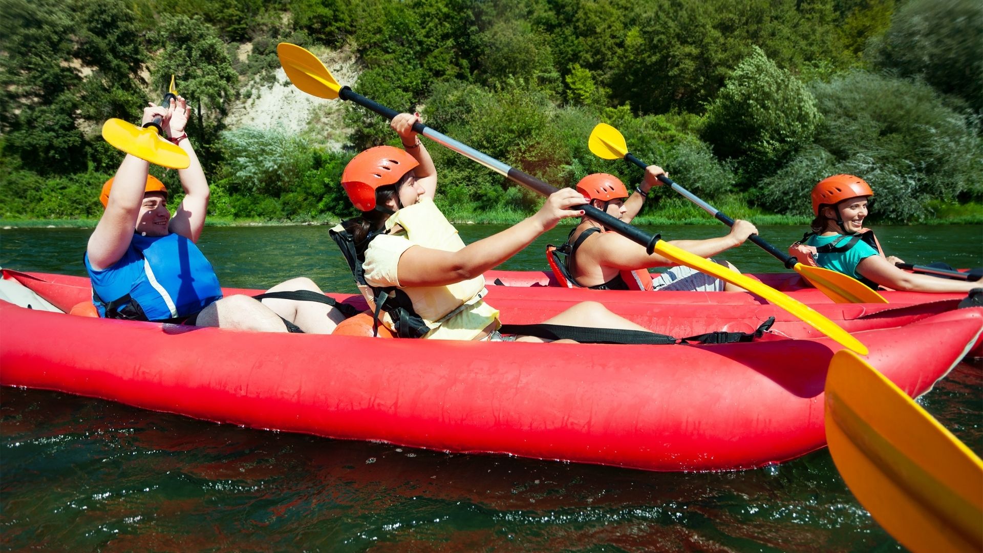 people river rafting in inflatable canoes