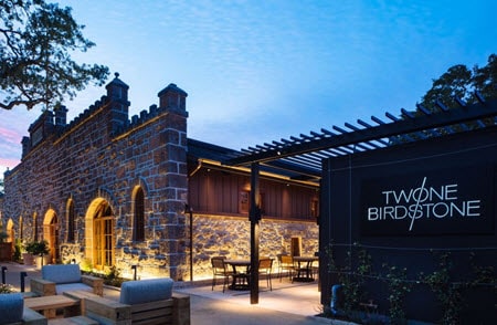 Exterior view of stone building of Two Birds One Stone Restaurant in St. Helena, CA, in the Napa Valley Wine Country