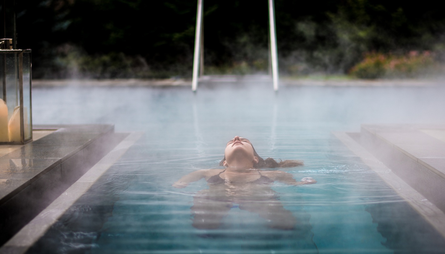 Woman Swimming In Geothermal Pool in California
