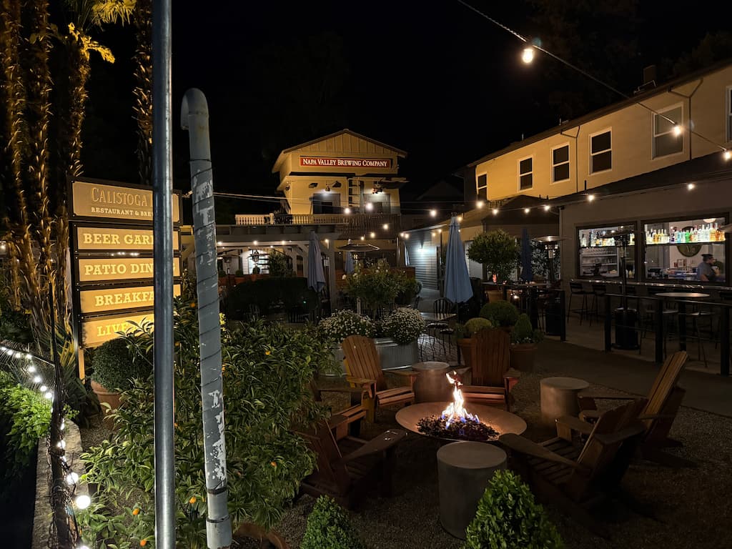 An outdoor fire pit surrounded by wooden Adirondack chairs at Calistoga Inn
