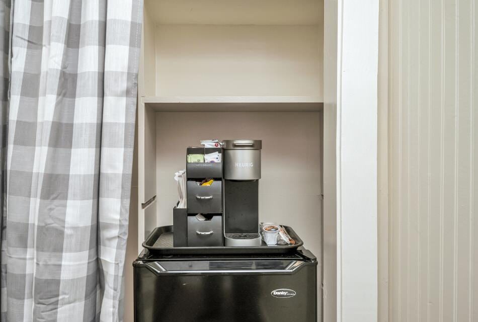 Keurig coffee maker on top of black mini fridge