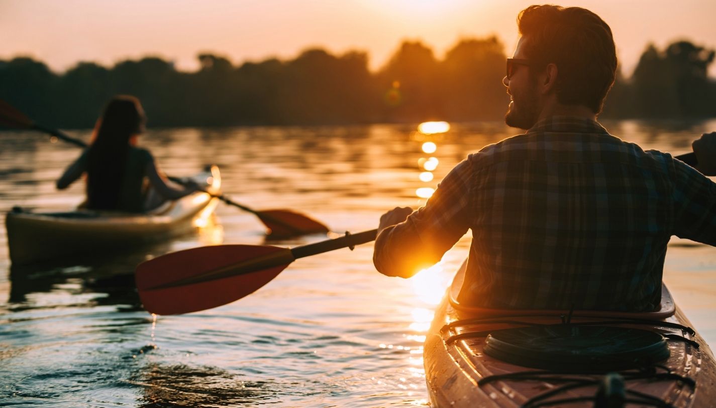 A couple kayaking together at sunset in California