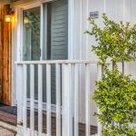Back patio entrance to Calistoga bedroom surrounded by green potted trees and bushes
