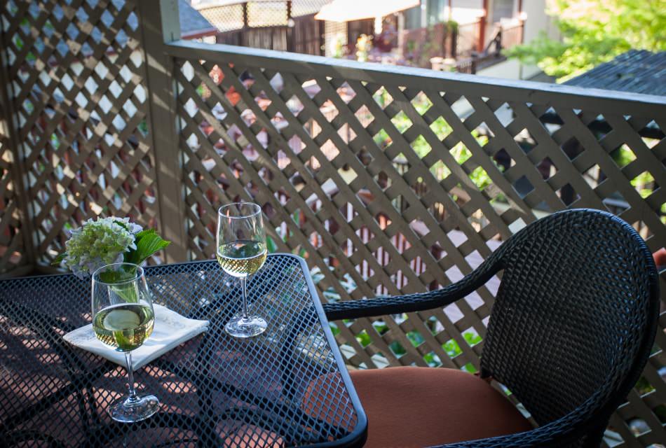 Close up view of two wine glasses with white wine on metal patio table