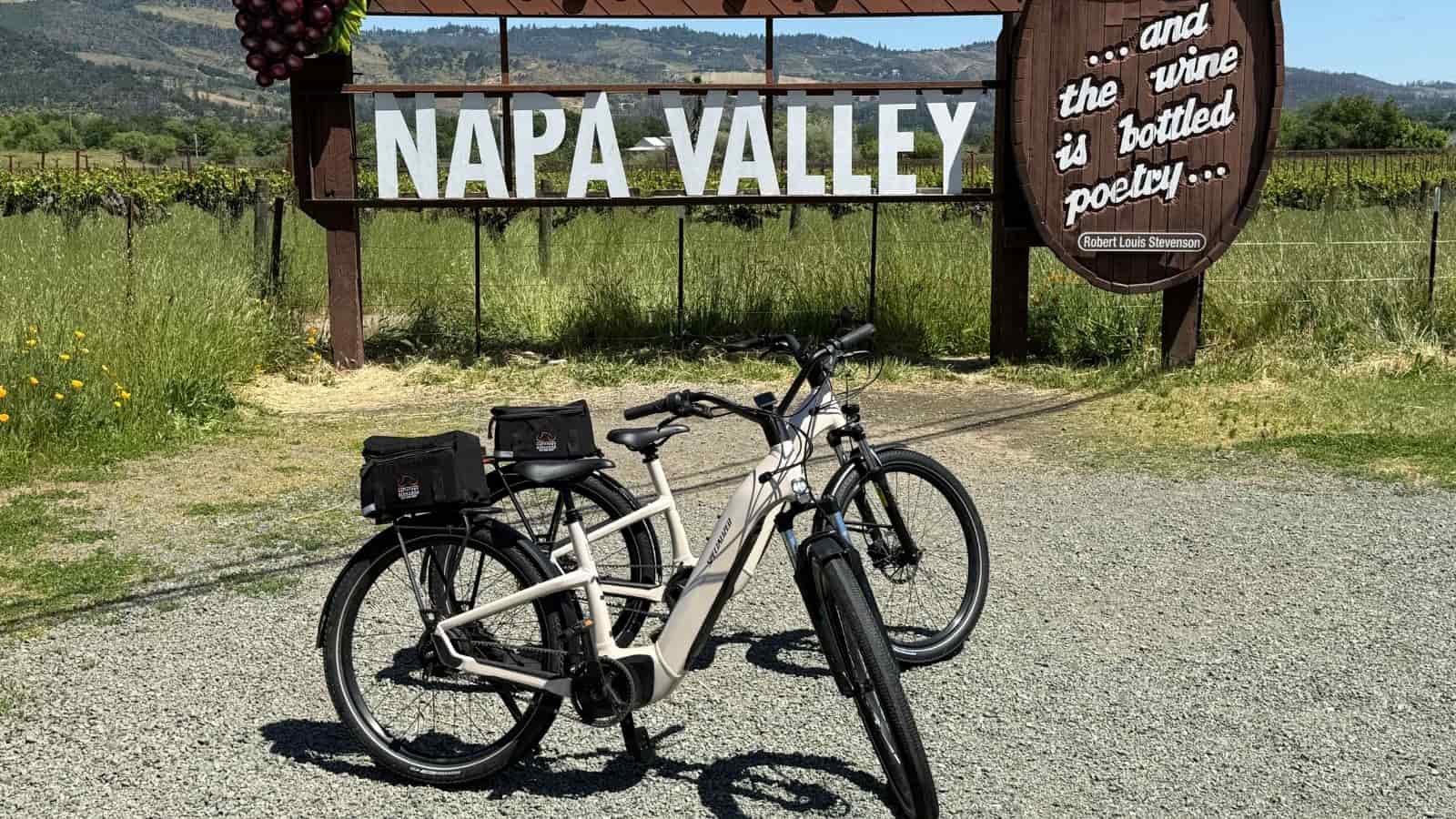 A pair of bikes in front of the Napa Valley sign