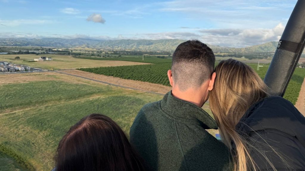 A couple looking over the vineyards during a Napa Valley hot air balloon ride