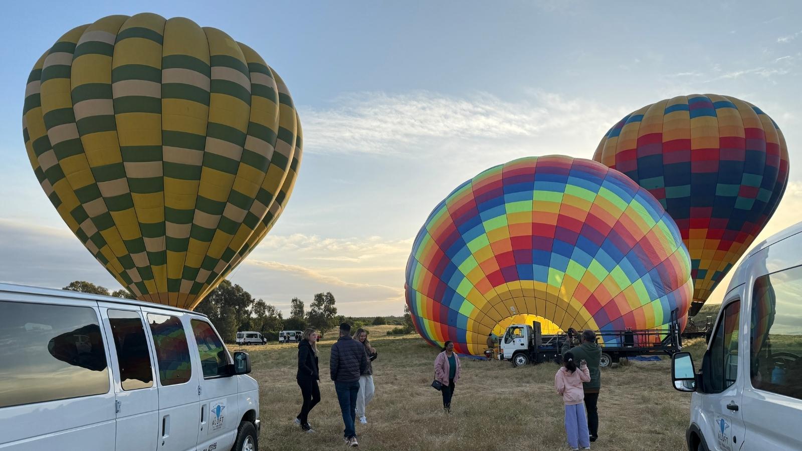 A group of people waiting for their hot air balloons to inflate for a Napa Valley hot air balloon ride