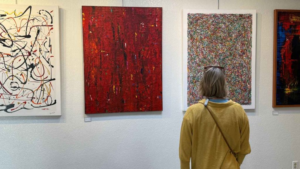 A woman looking at art at the Steve Rogers Gallery in Yountville, CA