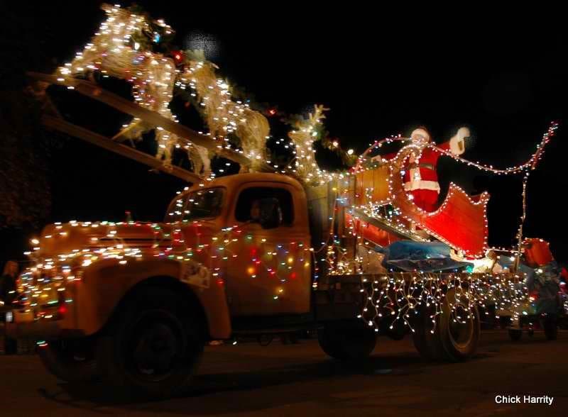 Lighted Santa Claus tractor outside at the Calistoga lighted tractor parade.