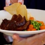 Beef bourguignon with carrots and peas in white bowl at Bistro Jeanty Restaurant in Yountvulle, CA, in the Napa Valley Wine Country; fine dining