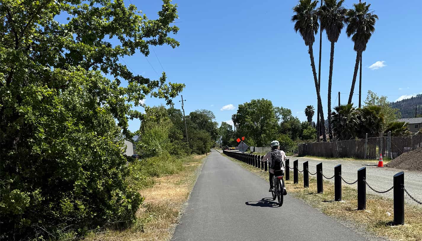 A cyclist riding along the Napa Valley Vine Trail